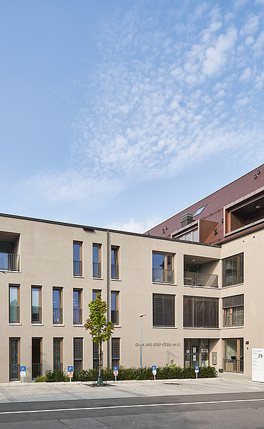 Foto Außenansicht Gebäude mit Eingang und Parkplätzen