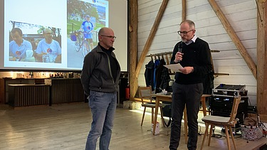 Foto 2 Männer auf einer Bühne